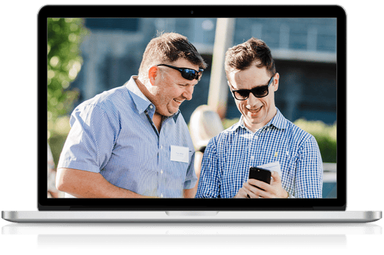Director and client engaging in managed IT support on mobile phone