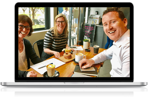 Office Solutions IT Manager meeting clients in a cafe